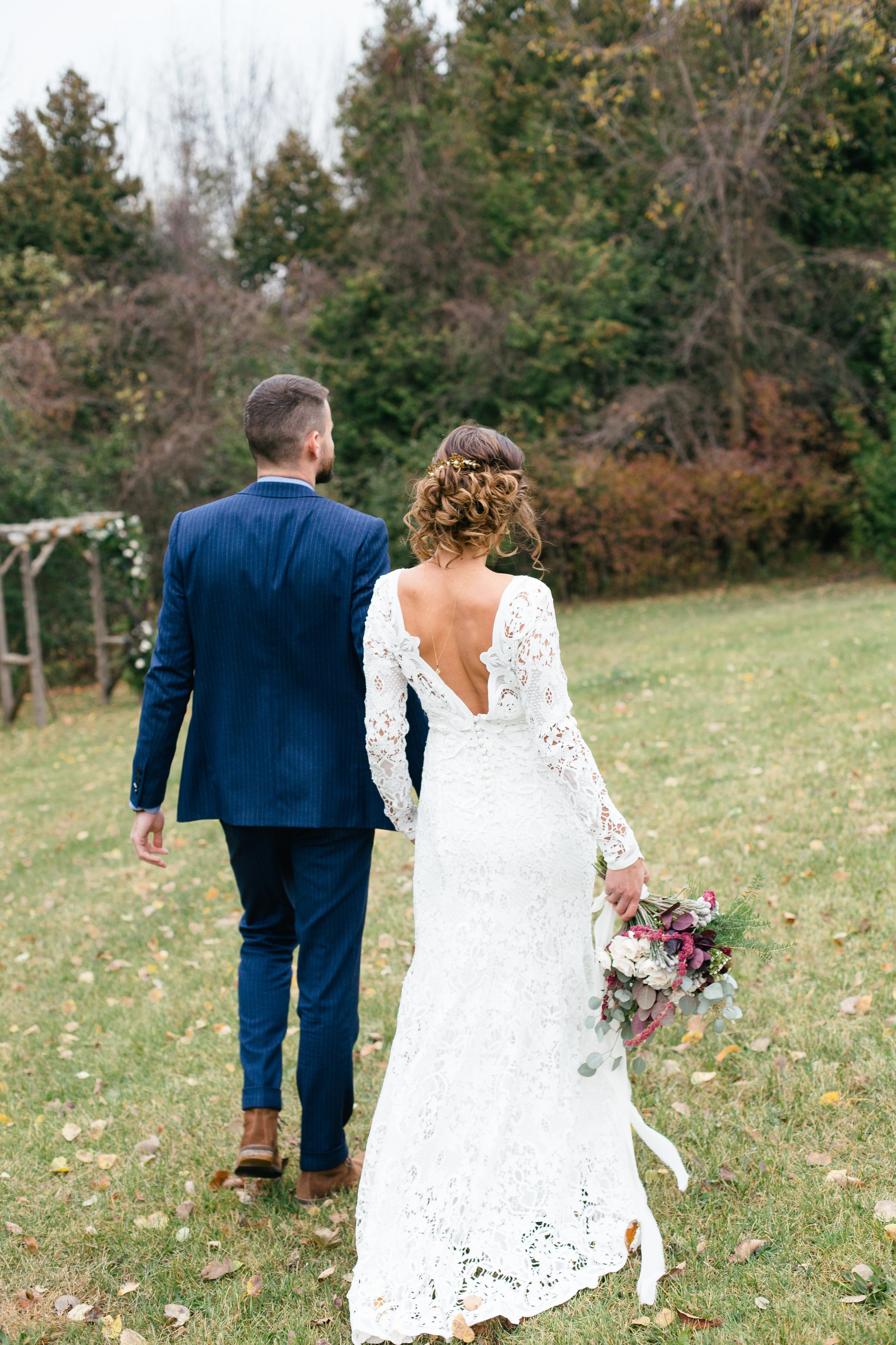 bride-and-groom-walking-on-the-grass.jpg